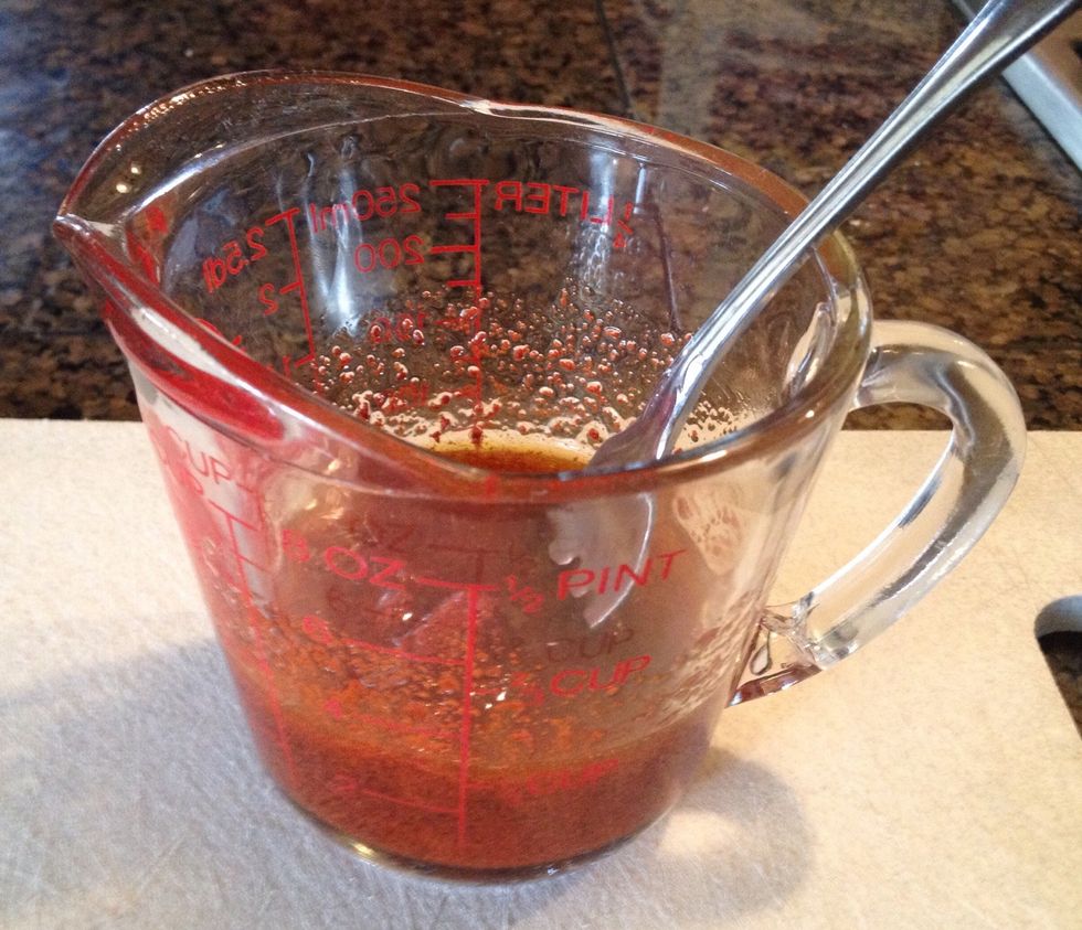 Mix the achiote paste into the olive oil with a fork until it becomes a smooth mixture. It should now reach the 3oz line on your measuring cup.