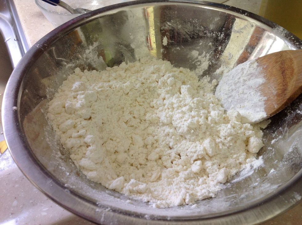 Mix the butter to the flour by chopping it down, until it gets to the size of a small bean. After you're done, add the milk.