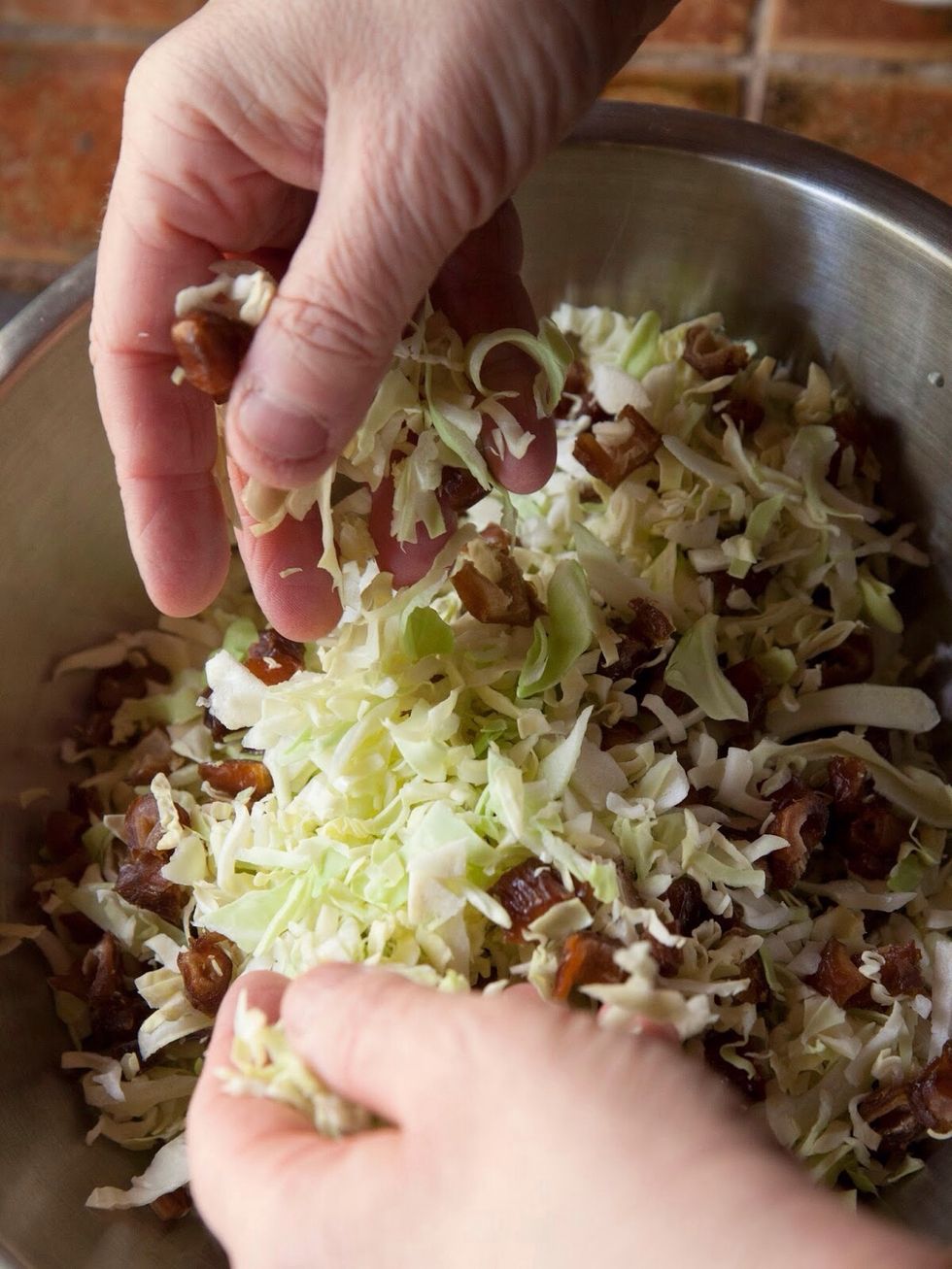 Mix the chopped dates into the chopped cabbage and set them aside.