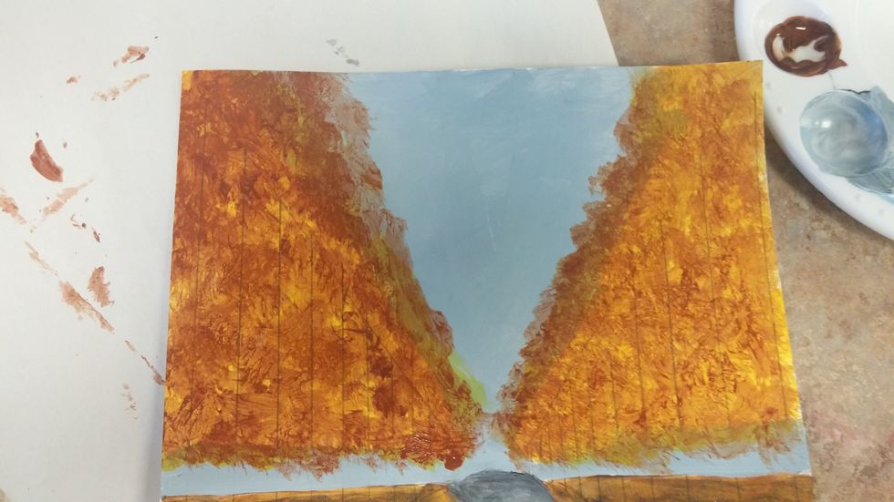 Mix the color you most see in the leaves (fall has this warm brown). Dab and dot all over the base color, allowing for some of the base color to show through.