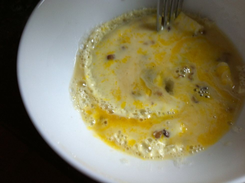 Mix the cooked part on the side of the bowl with the uncooked eggs.