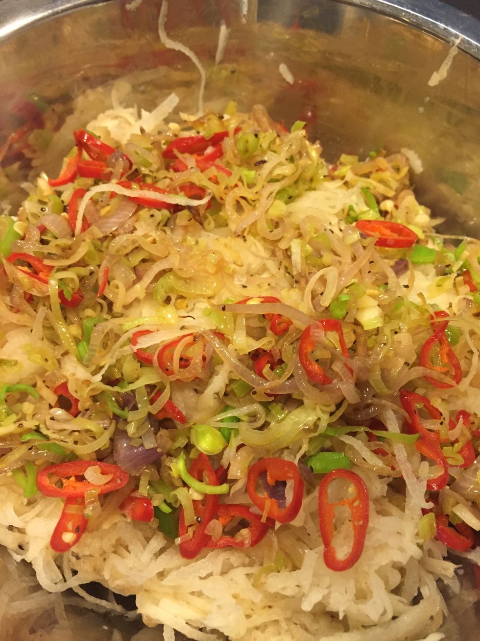 Mix the cooled spicy onion mixture and blend well with the potatoes. Making sure it's well combined so all the seasoning is infused with the potatoes.