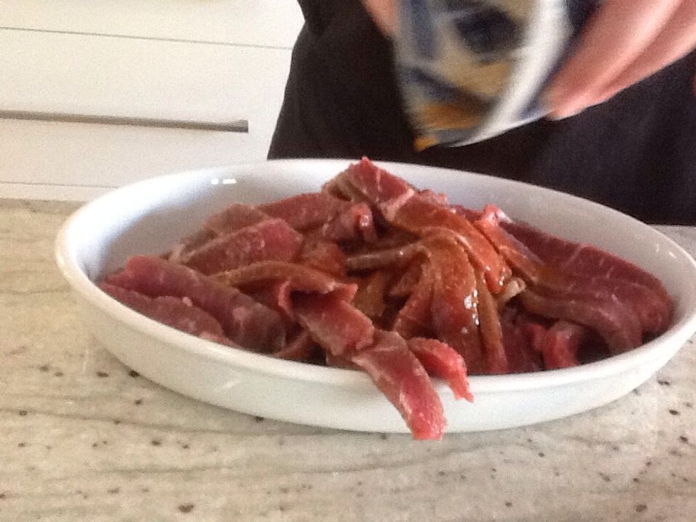 Mix the corn flour, oil and soy sauce in a bowl and pour over the beef.