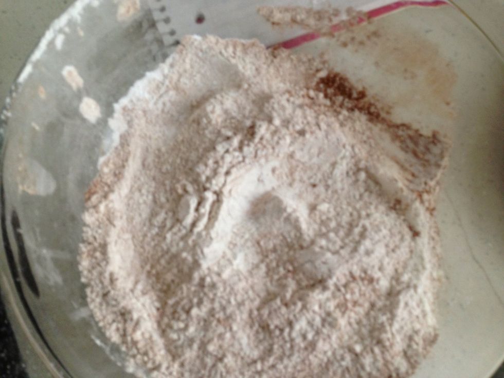 Mix the dry ingredients in a large bowl. This is the flour, baking powder and cinnamon. In a separate bowl, whisk together the tofu, 1 cup sugar and 2 tbsp oil.