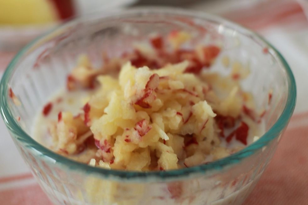 Mix the grated apple in well. Scoop out as much as you want to eat into a bowl (and save the rest covered in the fridge for tomorrow).
