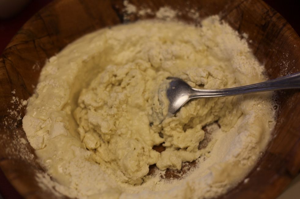 Mix the hot water and flour from the inside and work your way outside until there's no more flour stuck to the bowl and the hot water should have cooled down a bit ready for your clean hands