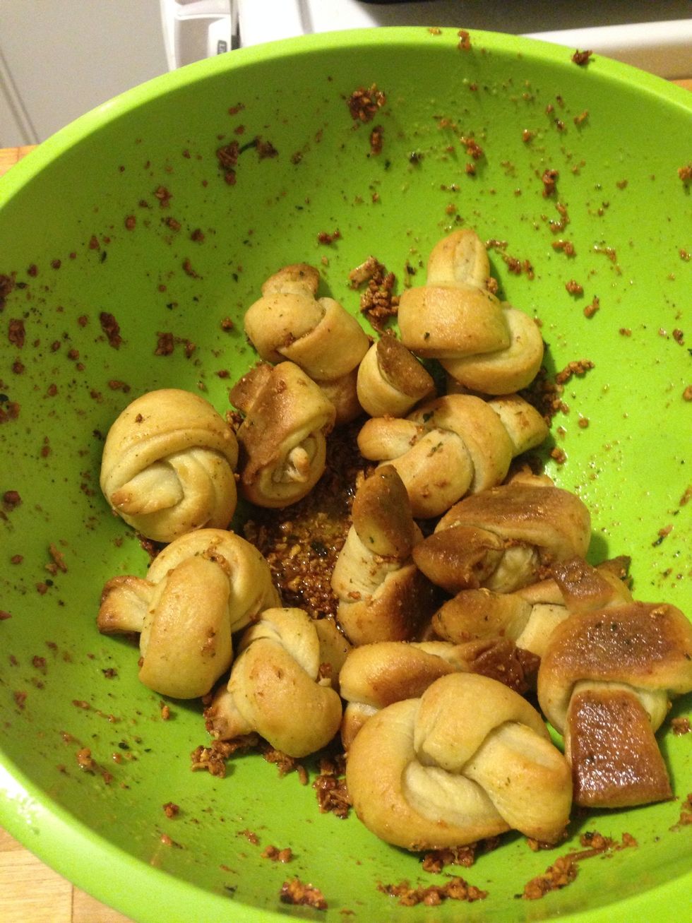 Mix the knots in the sauce. Let the rolls sit for at least 5 mins to absorb the olive oil. Add additional garlic salt if desired. I bet these also taste good with Parmesan cheese.