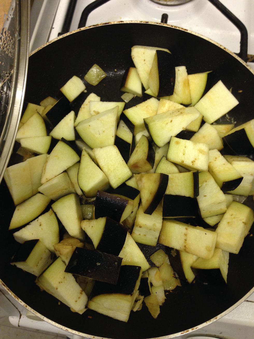 mix the onion and garlic with the chopped aubergine into a hot pan