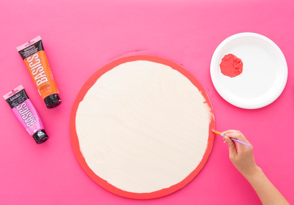 Mix the pink and orange paints together and paint around the edge of the circle. Then, mix the pink and the white paints together.