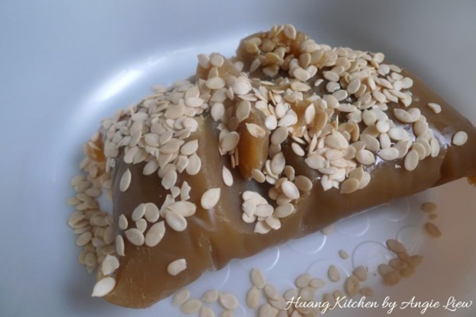 Mix the toasted melon seeds into the lotus paste. Lightly knead to combine the melon seeds into the paste.