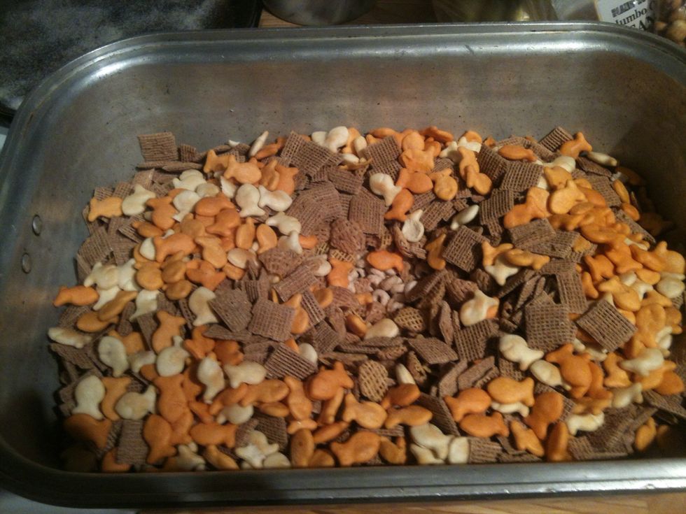 Mix together cereals, peanuts, pretzels, roasted corn and goldfish in a large roasting pan or two. Put in preheated oven ( 250F ) to warm up, maybe 5-10 mins. Total time approx. 1-2 hrs.
