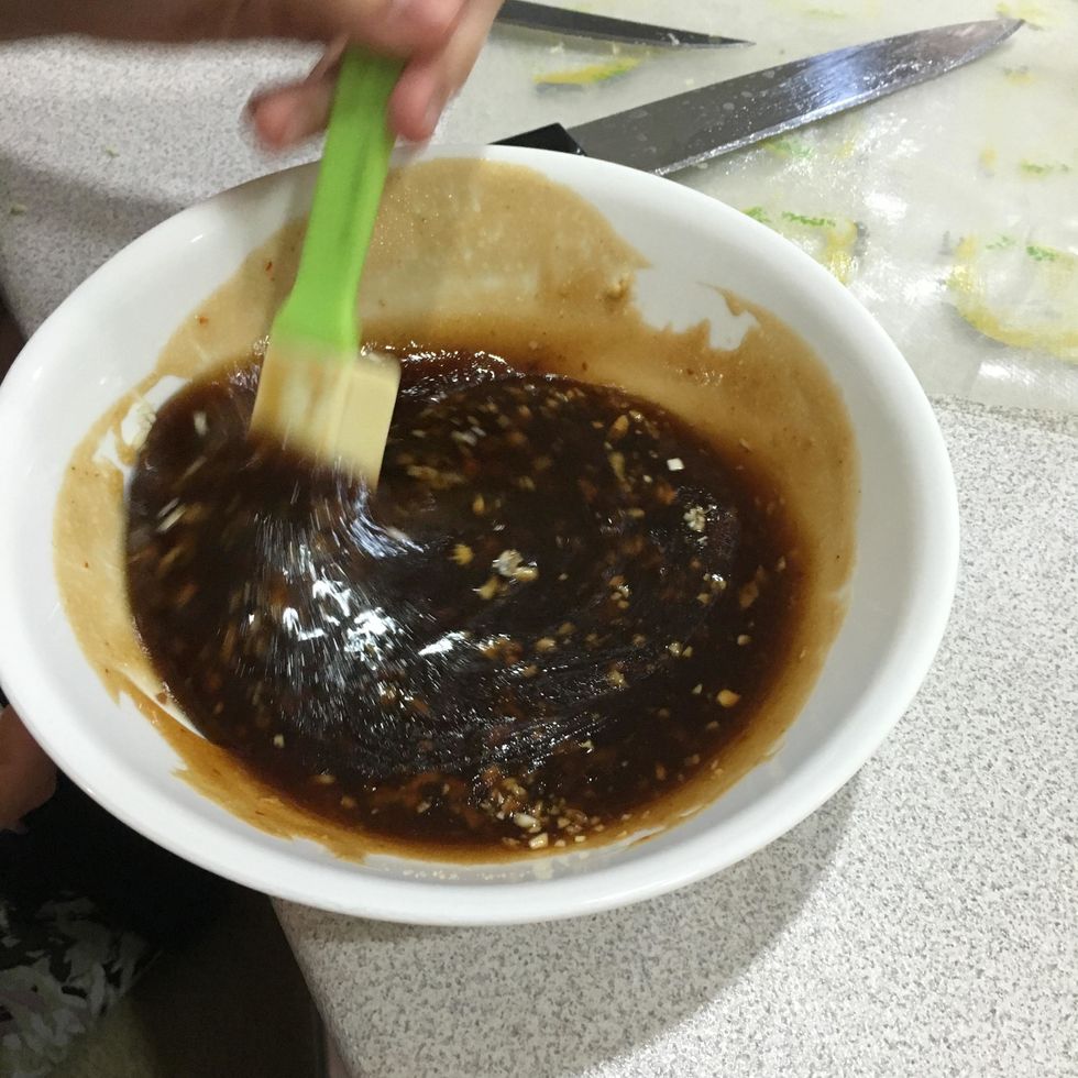 Mix together the teriyaki sauce, honey, brown sugar, olive oil, ginger and 2 cloves of garlic