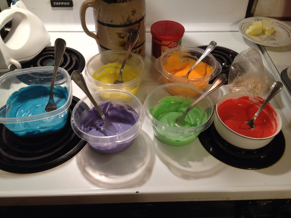 Mix up cake batter according to directions on box. Separate batter into six bowls and add Wilton icing colors (red, orange, yellow, green, blue, and purple) to each bowl.