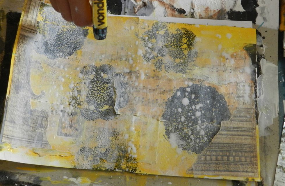 Mix water and acrylic gesso and place it on a spray bottle. Spray it on the pages.