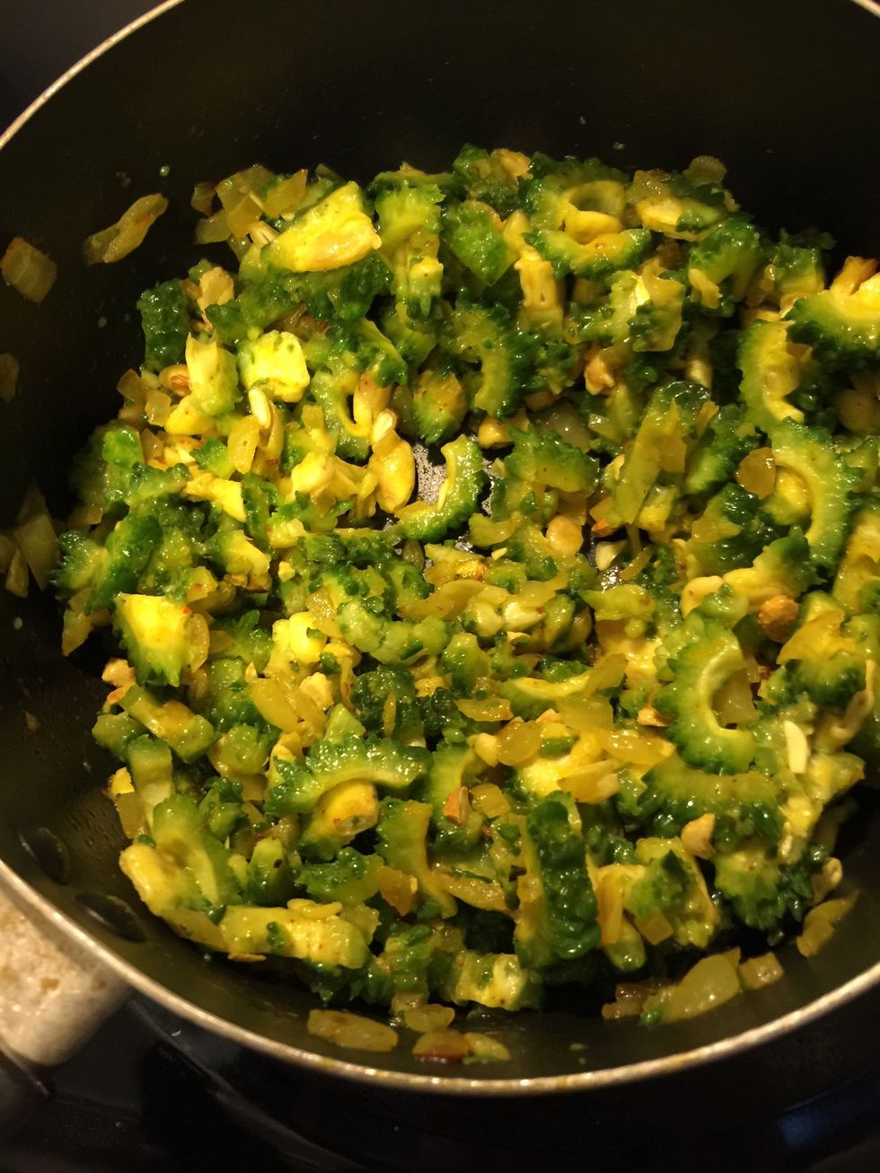 Mix well and let it cook. Karela has a lot of water, so keep it on medium flame, no lid and let it cook. Sit every 5 mins, so it doesn't stick to the pan. Cook for about 20 mins.
