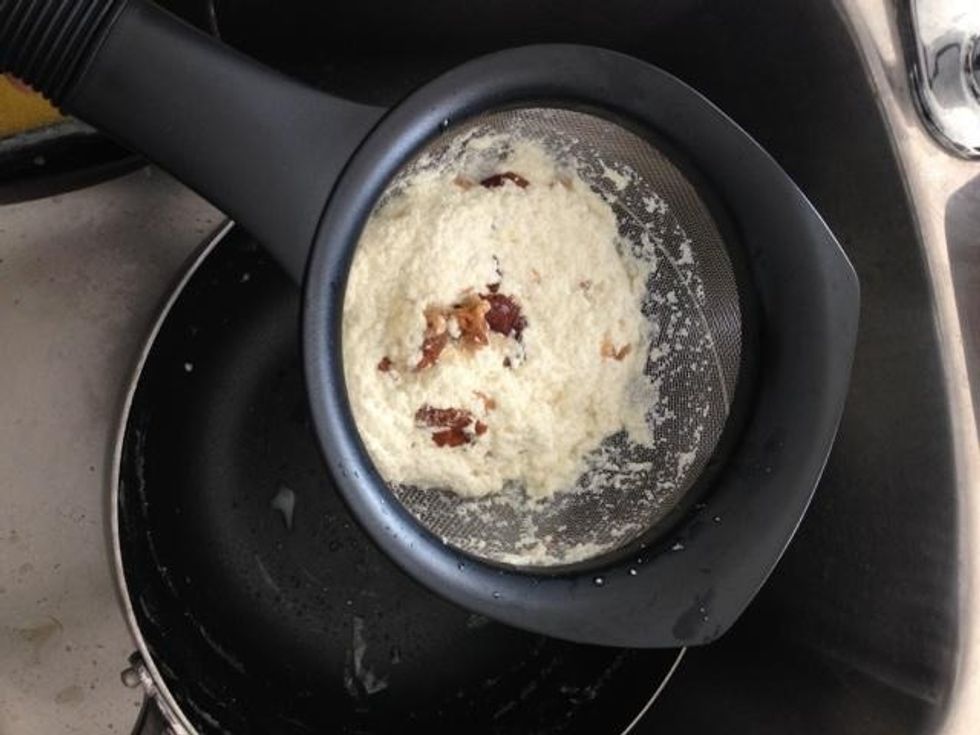 Mix well for a bit until the paneer thickens and then strain out the entire milk into the sink. This will separate the paneer into the strainer.