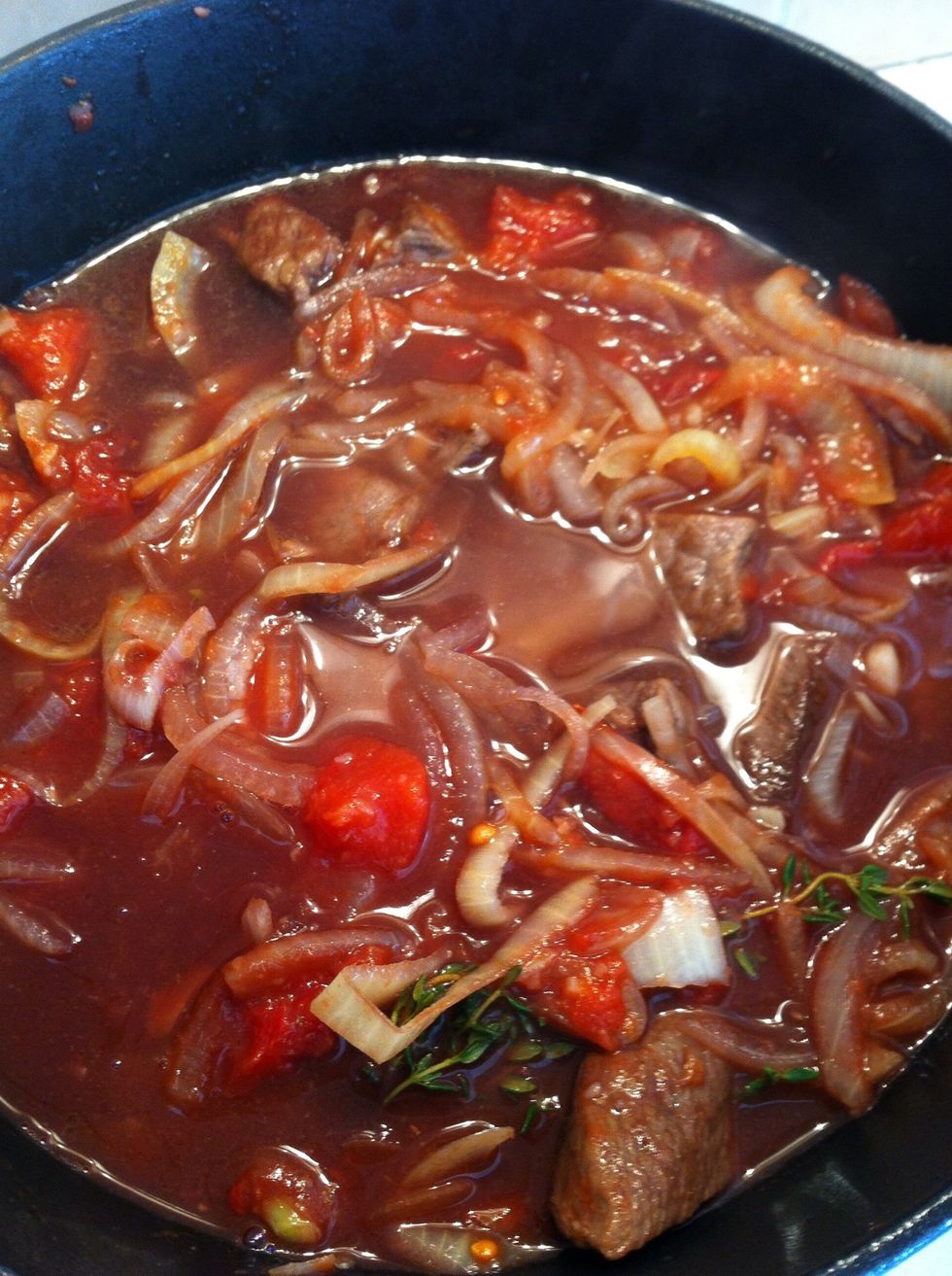 Mix well to leave beef sit comfortably in sauce, put the lid on and put into the oven. Now enjoy the rest of the red wine and come back in two hours, put the veggies in for half an hour more.