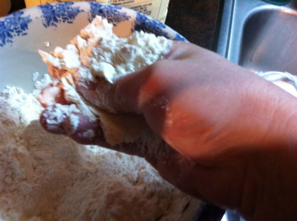 Mix with the flour. It's like when you was a kids, squeezing sand and water in your hands.