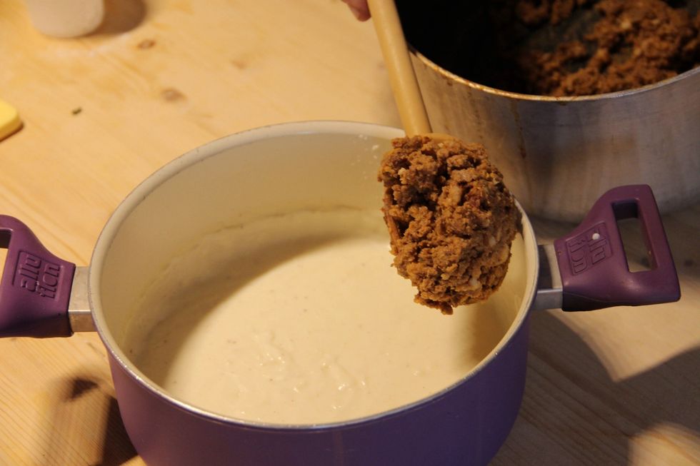 Mix your cooked ragu with your fresh bechamel sauce