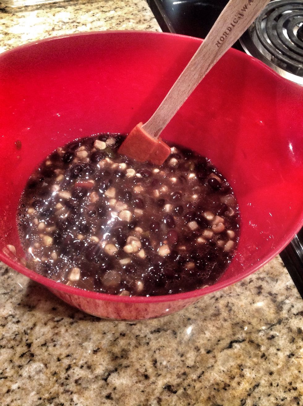 Mix your corn and black beans in a bowl, drain any access juice created by the stirring then pour the mixture over the chicken and tortilla layers.