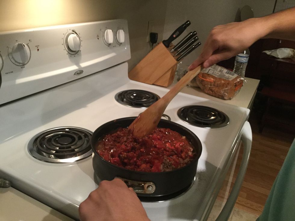 Mixing around the chili to cook all of it