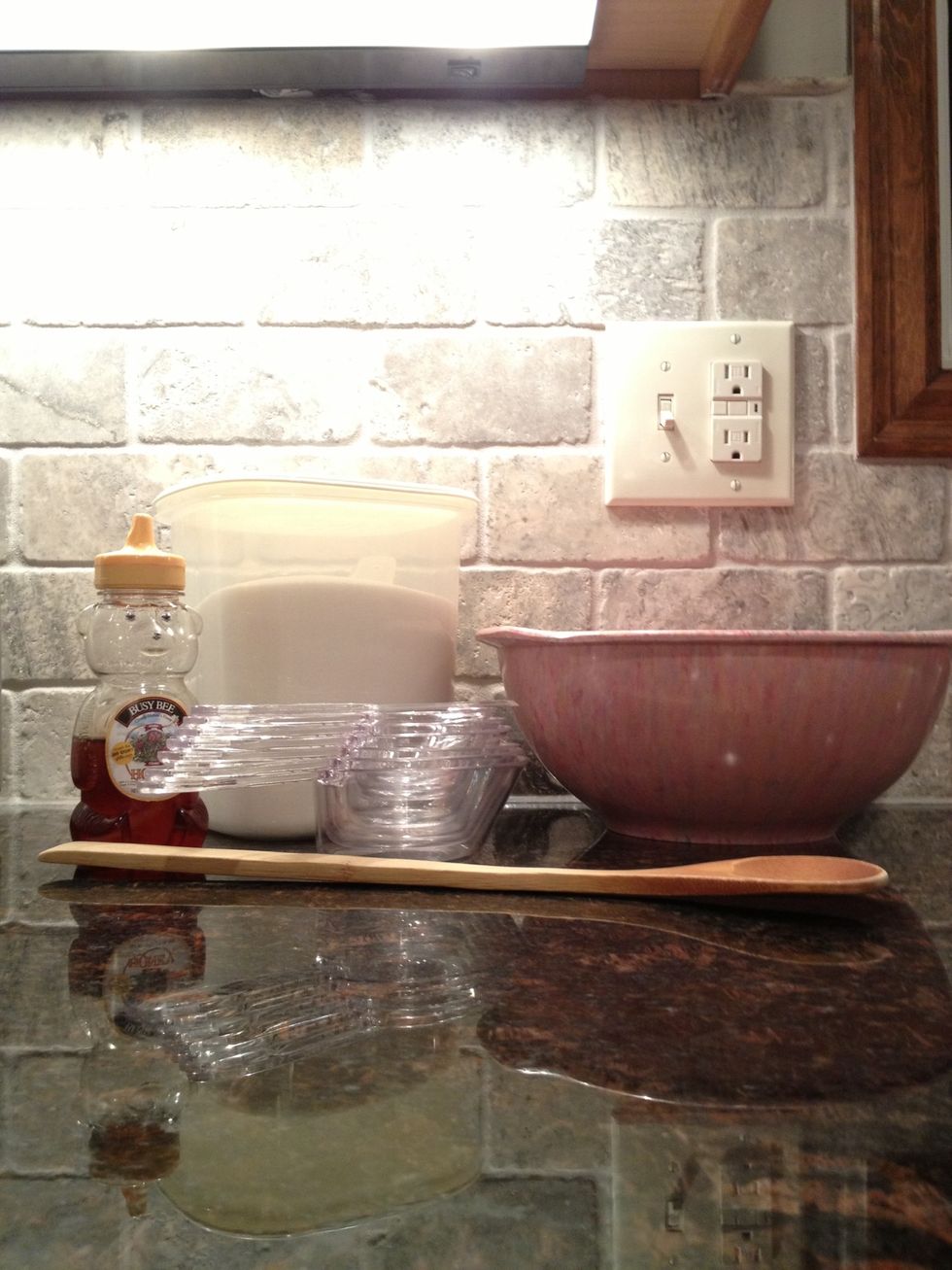 Mixing bowl, spoon, honey, measuring cups, teaspoon, vanilla, and sugar.