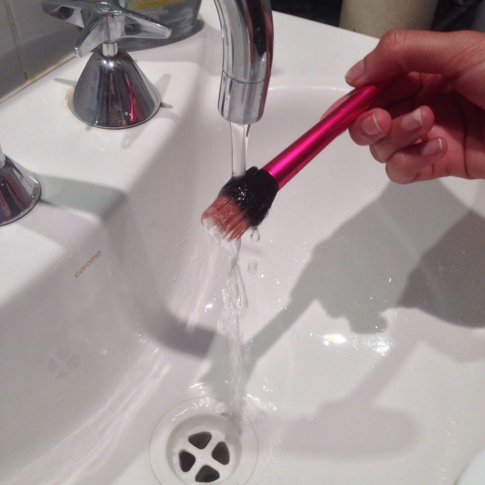 Moisten dirty brush under warm running water
