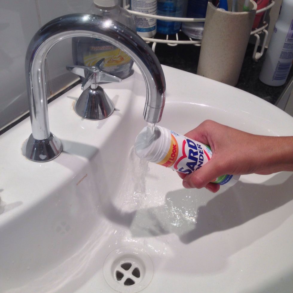 Moisten stain remover stick under warm running water