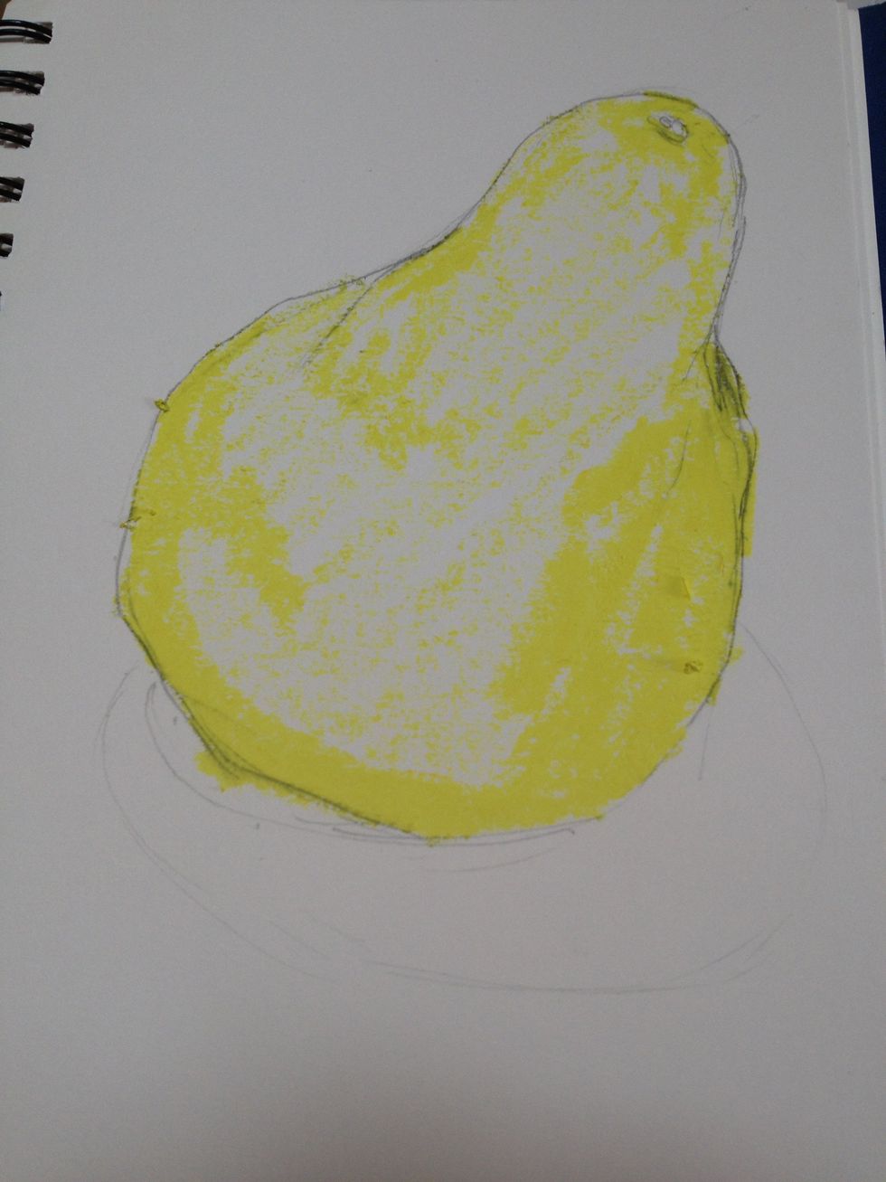 More yellow where there is a stronger yellow color to the pear and where there is more light including the reflected highlight on the left bottom from the table.