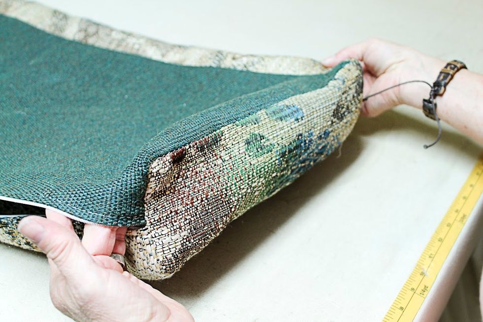 Most camper cushions don't have the 2 piece - zipper placket.  Instead the top and bottom are cut longer, to wrap around and meet at the bottom.   The zipper is sewn to those pieces as shown here.