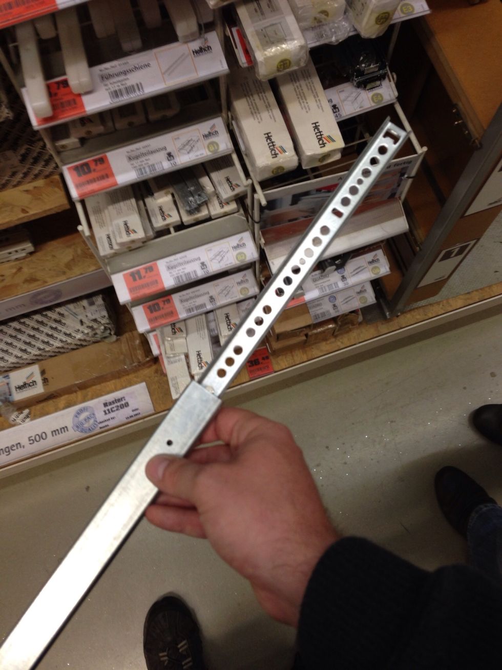 Mount the top board using the drawer slides like these. You can get them in most hardware stores or from old drawers. Screw them to the top board and the bottom part.