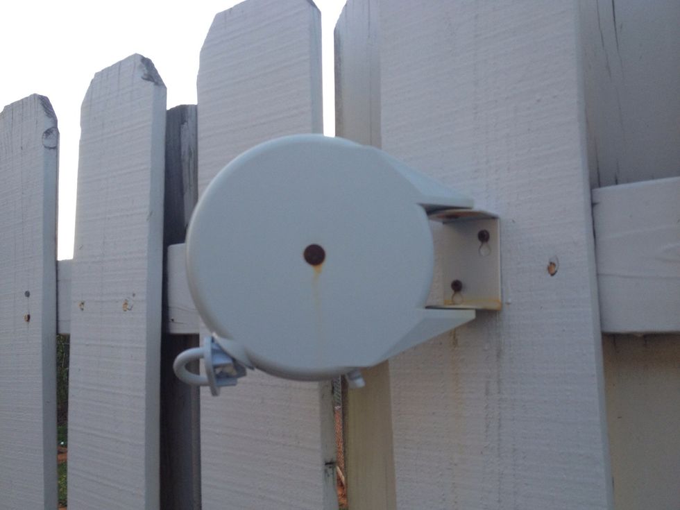 Mounted on the fence, using the supplied screws