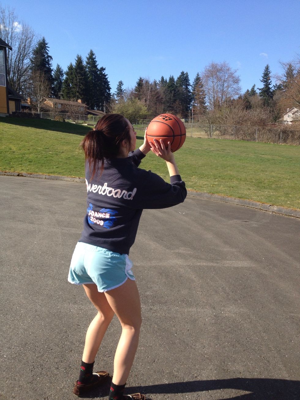 Move ball to shot pocket. Shooting hand in the center of the ball and your off hand resting on the side for guidance