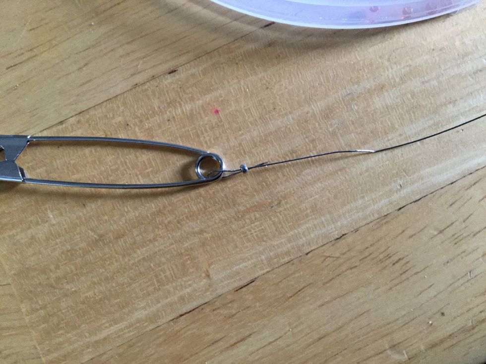 Move crimp bead as close to the pin end as possible and then crimp.  Trim excess wire - carefully so you don't trim the main wire.