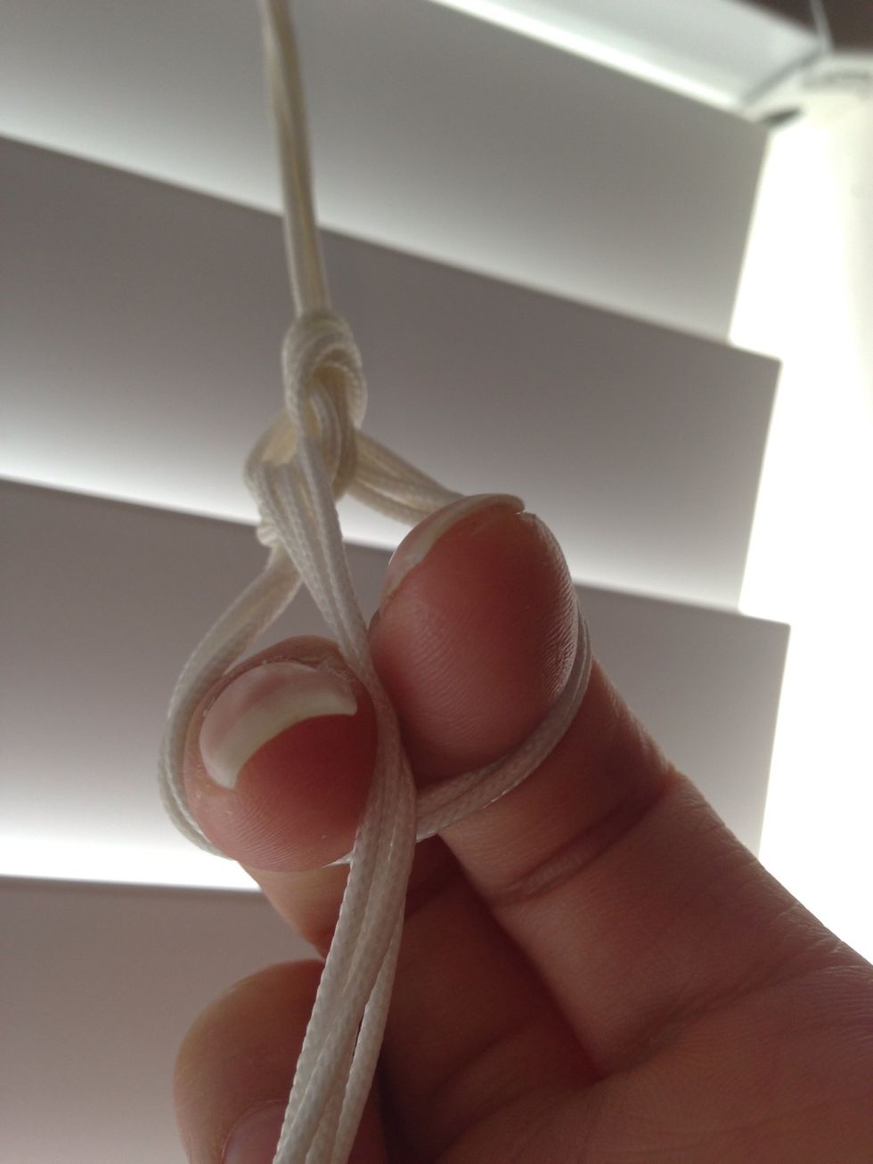 Move ends to between the fingers & pull through again.  Repeat until you're close to the end.  When you run out of cord, just pull all the ends through to tie off.