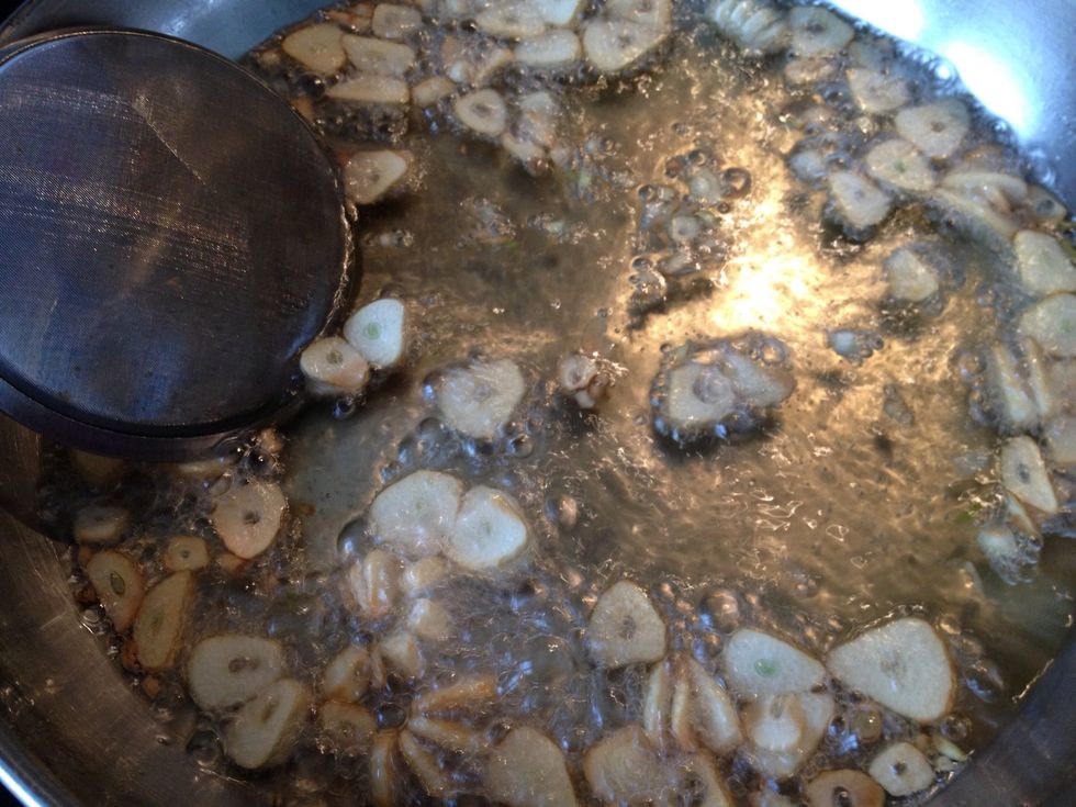 Move the garlic around to promote even cooking.