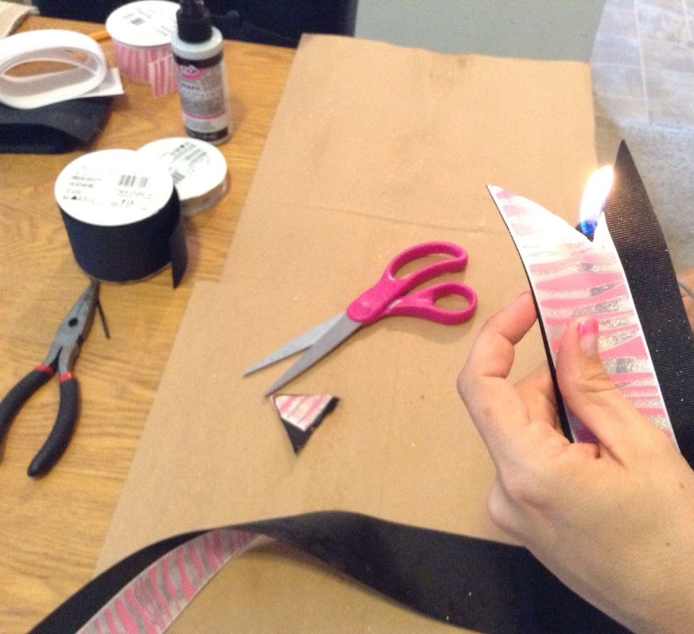 Move the lighter from one side of the ribbon to the other and do not linger in one area too long otherwise it will burn the ribbon.