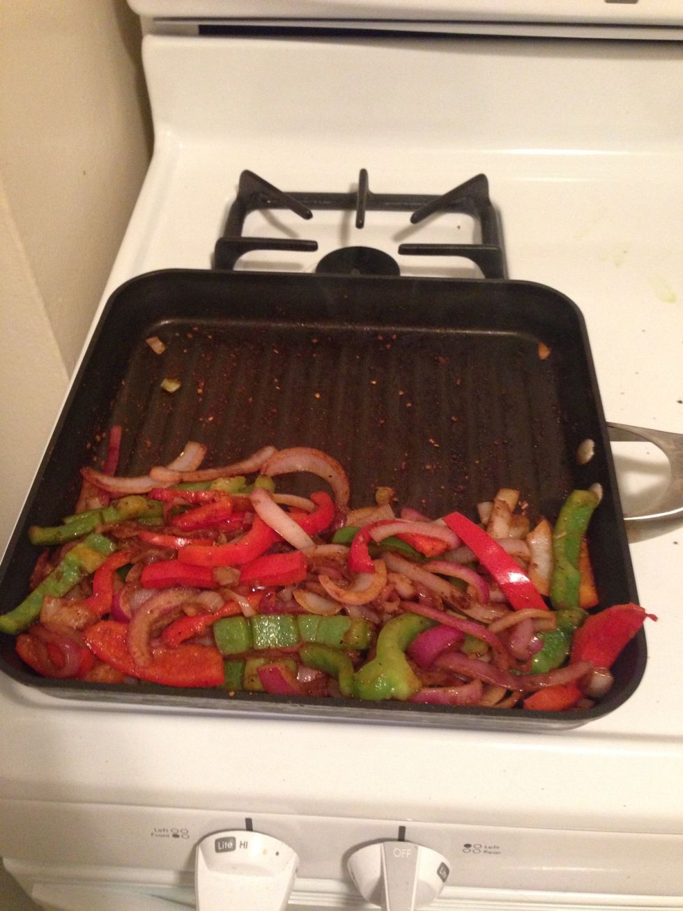 Move the onions and peppers to one side of the grill.