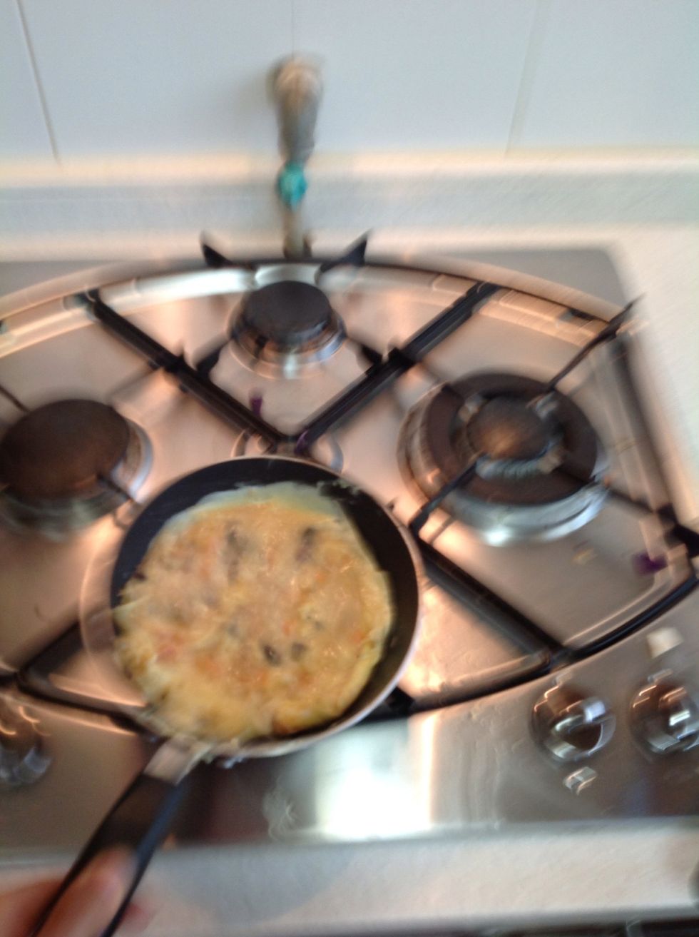 Move the pan and a back and forth motion to get the omelette to start to roll itself over a bit