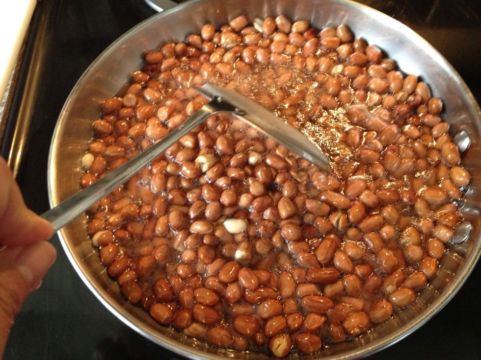 Move the peanuts around to promote even cooking. Fry for approximately 5 minutes.