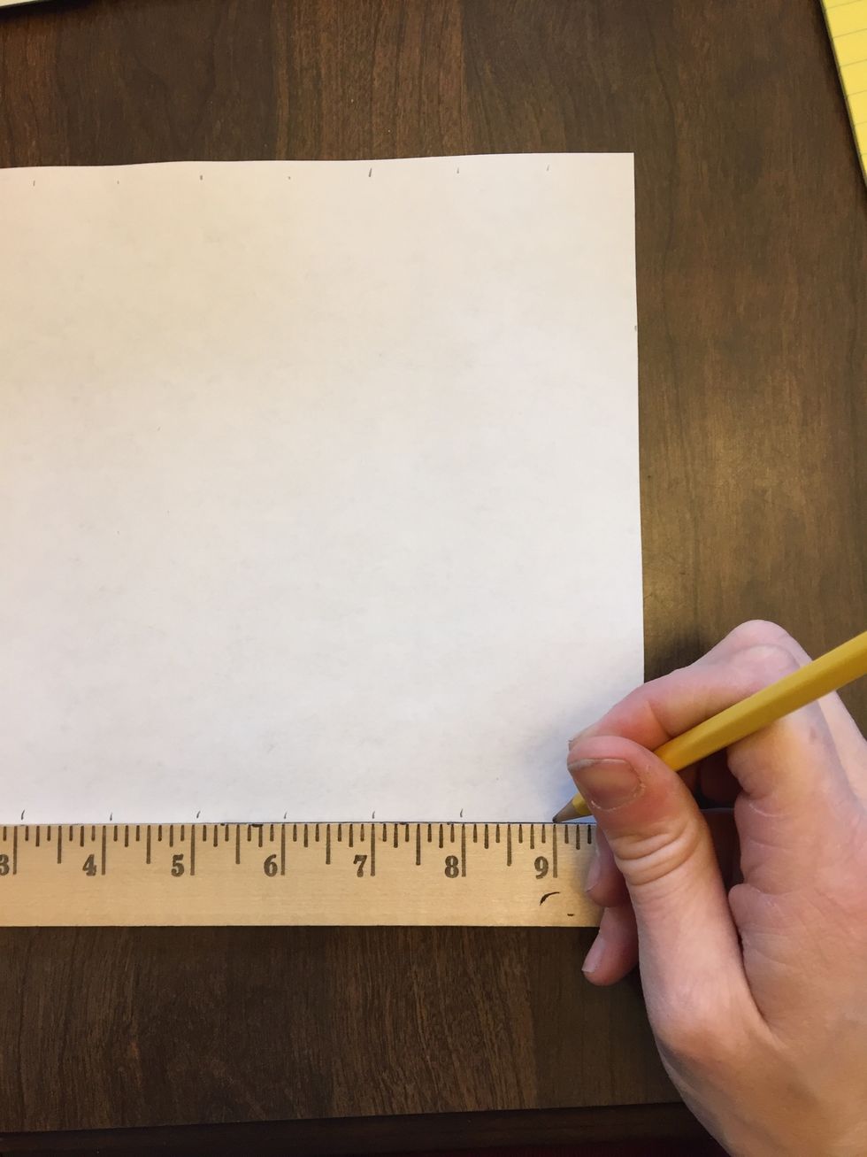 Move the ruler to the bottom edge of the paper and repeat the last step. When complete, you should have 9 marks along the top and 9 along the bottom.