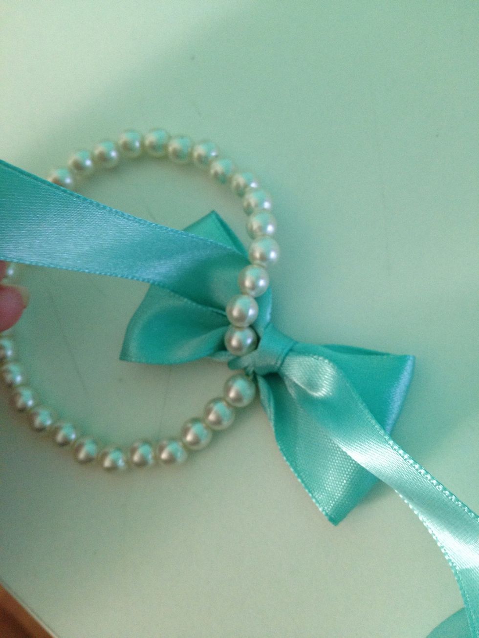 Move the two strands so that one is on the INSIDE of the bracelet (like the left strand in the pic) and the other on the outside.