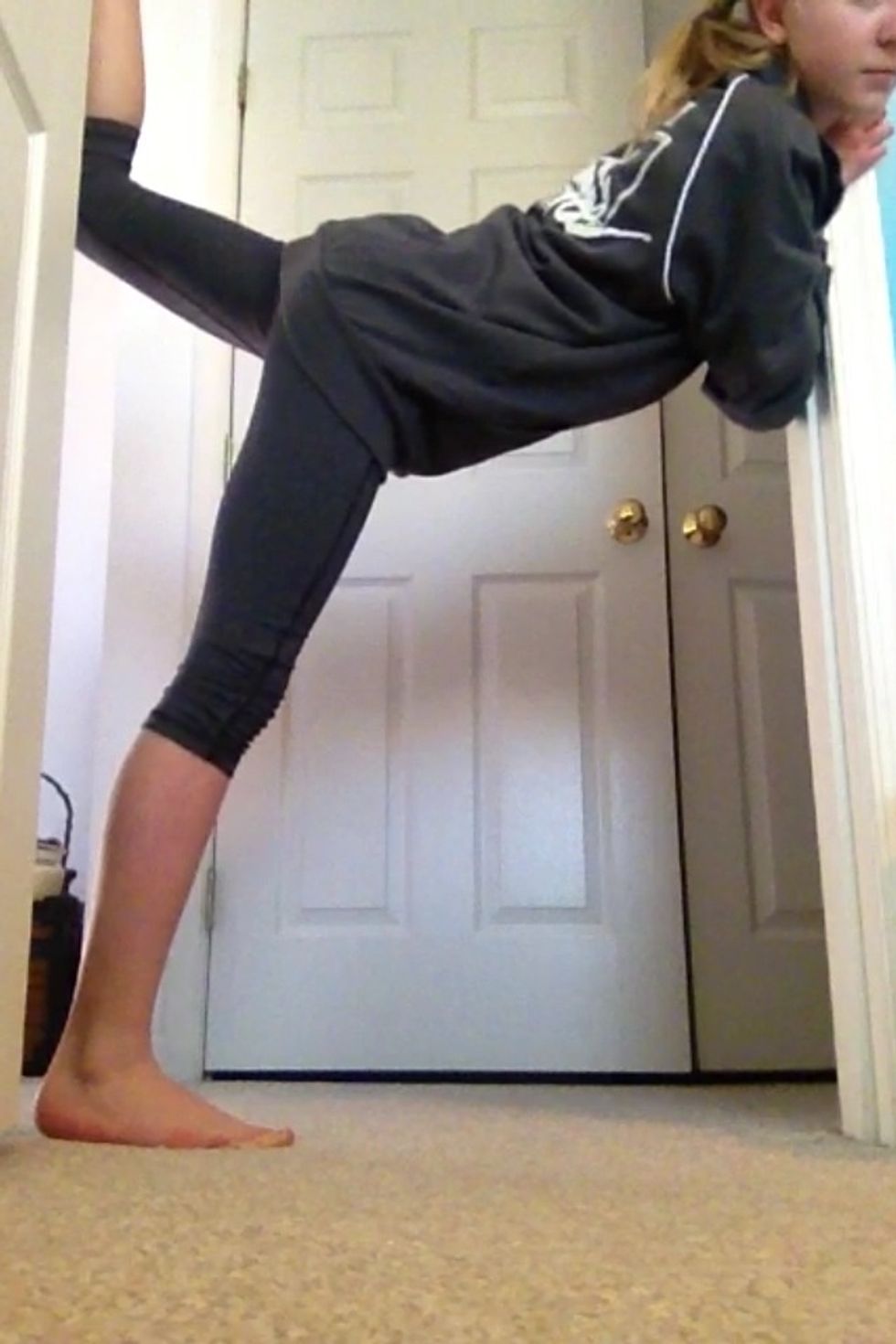 Move your base leg (leg on the floor) back untill it is close or next to the door. Start lifting your back leg higher and higher.