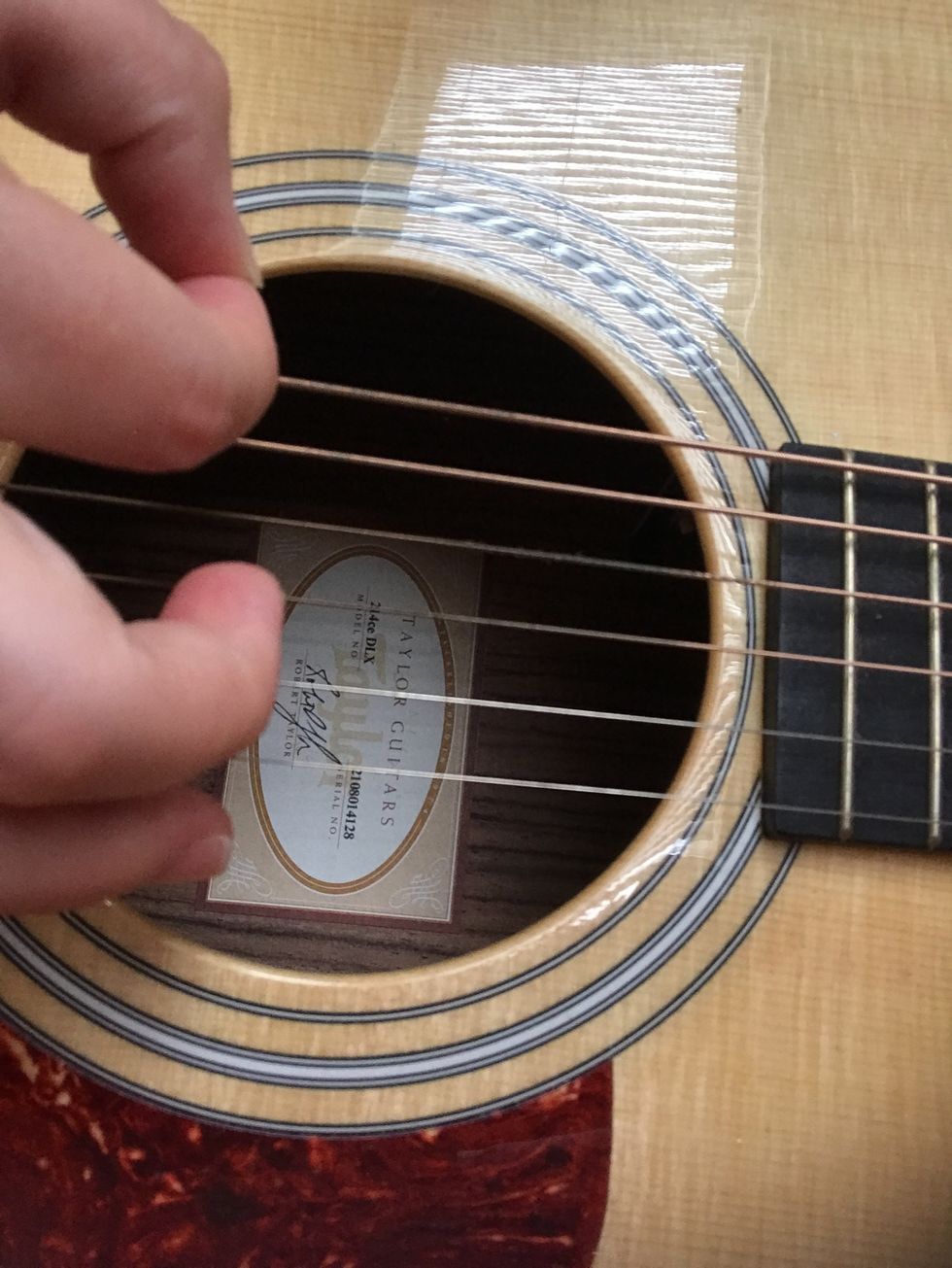 Move your right hand up and down, making sure the pick is strumming the strings over the sound hole. Keep a steady rhythm by tapping your foot or counting in your head.