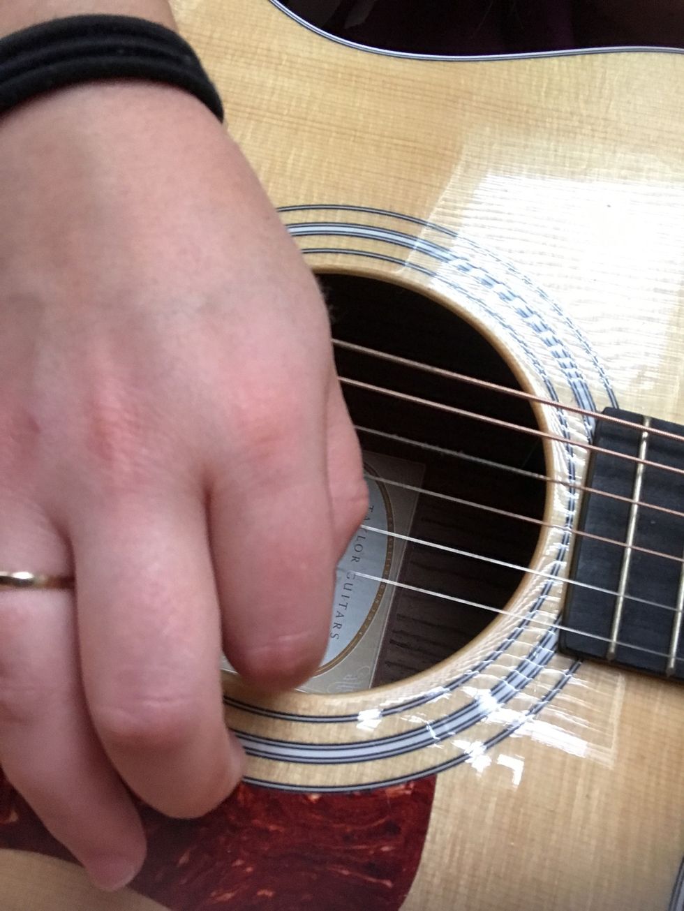 Move your right hand up and down, making sure the pick is strumming the strings over the sound hole. Keep a steady rhythm by tapping your foot or counting in your head.