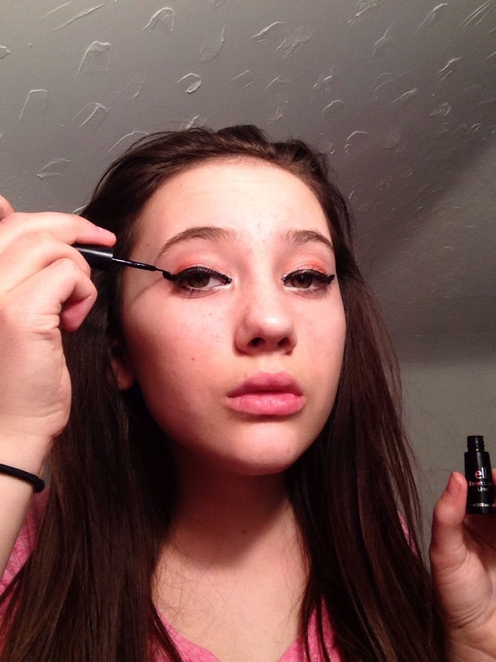 Moving on after eyeshadow, now apply winged liner. I can't explain how to do this, it just takes lots of practice (elf liquid eye liner).