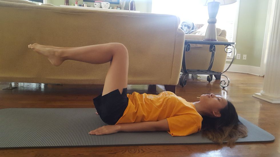 Moving onto a more gentle exercise, begin toe taps. Start in a position where your legs are at a 90 degree angle to your back and keep your back flat on the ground.