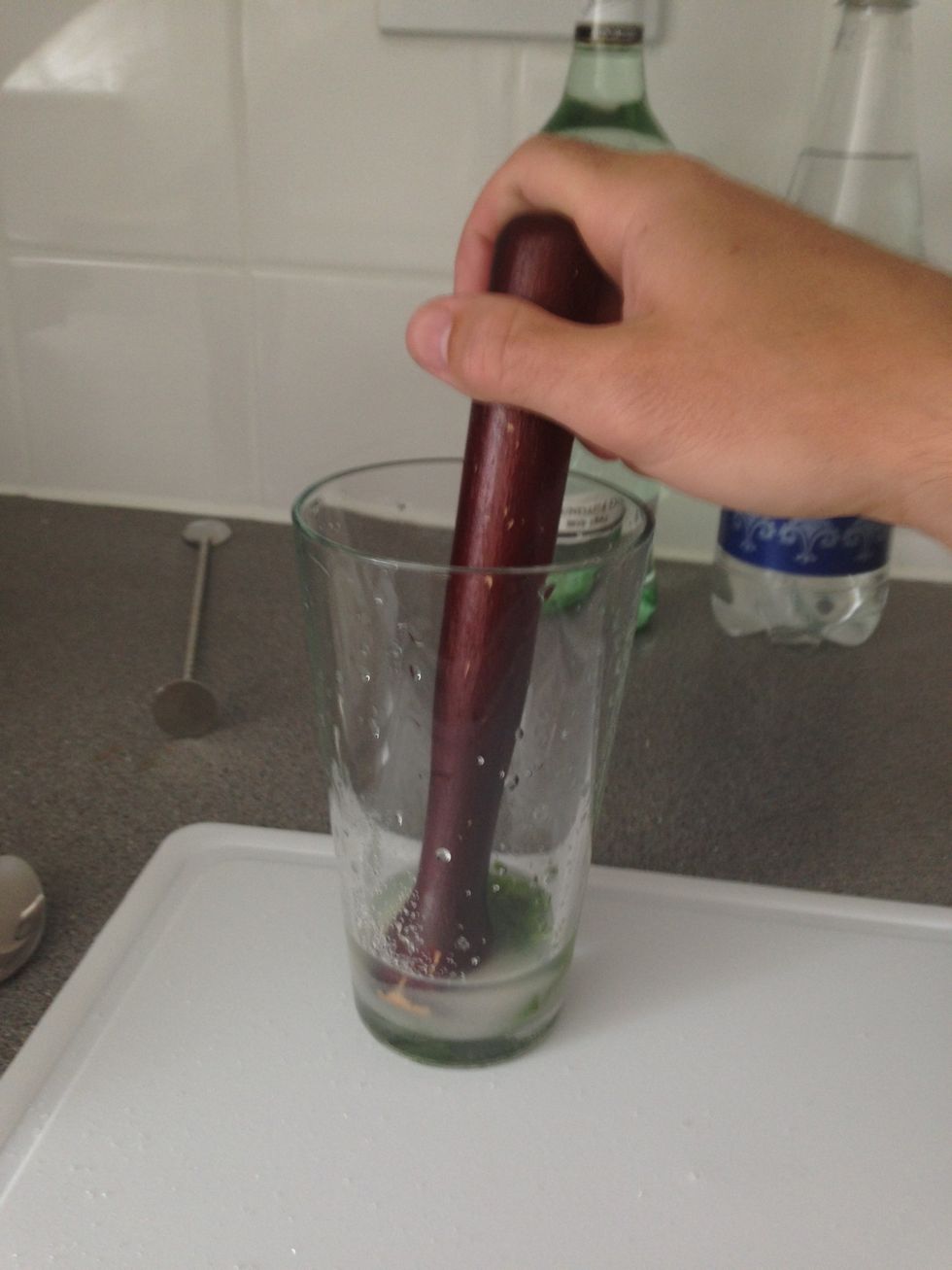 Muddle the ingredients gently together. You just want to release the flavour of the mint. Don't do it so hard that the leaves break up. The best way to muddle is push down with the muddler and twist.