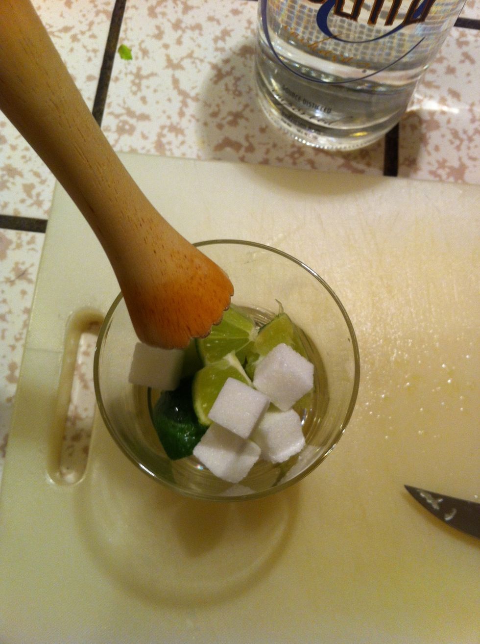 Muddle the ingredients, take your time and let the sugar bind with the lime juice.