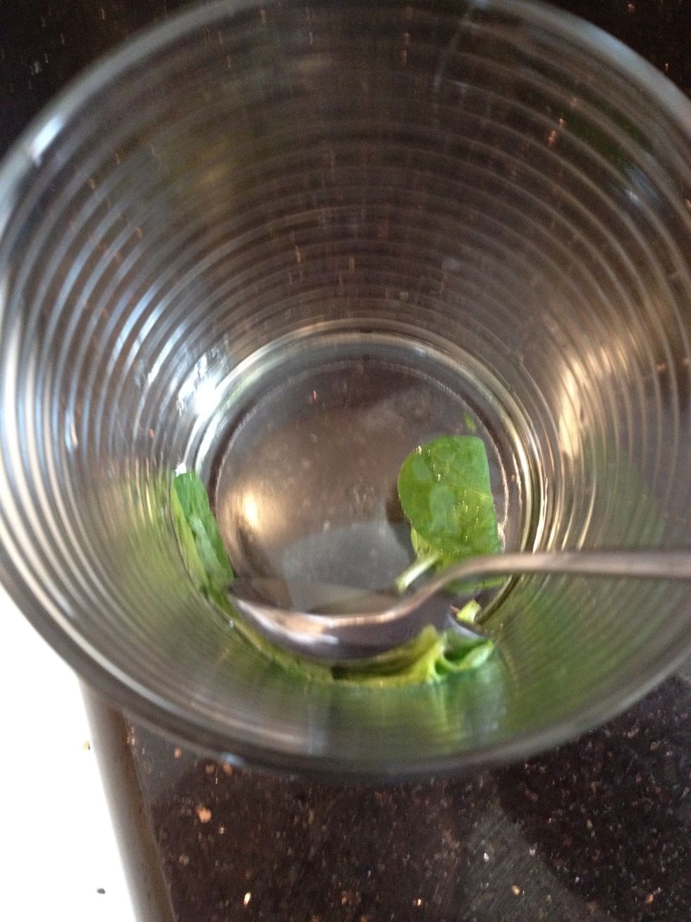 Muddle the leaves gently with a spoon to allow them to release their oils into the water/ syrup mixture.